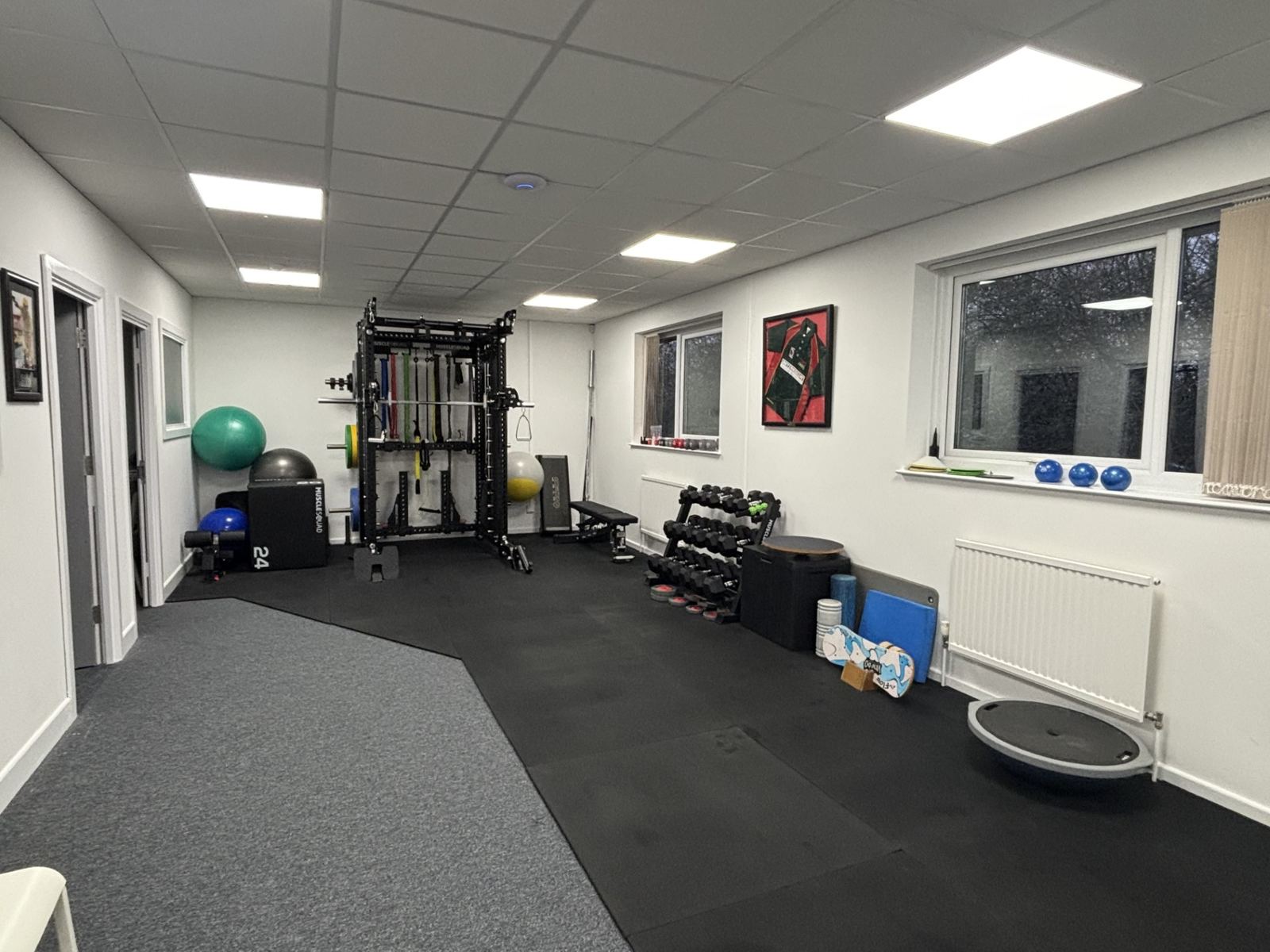 The open rehabilitation gym with racks, weights and exercise equipment