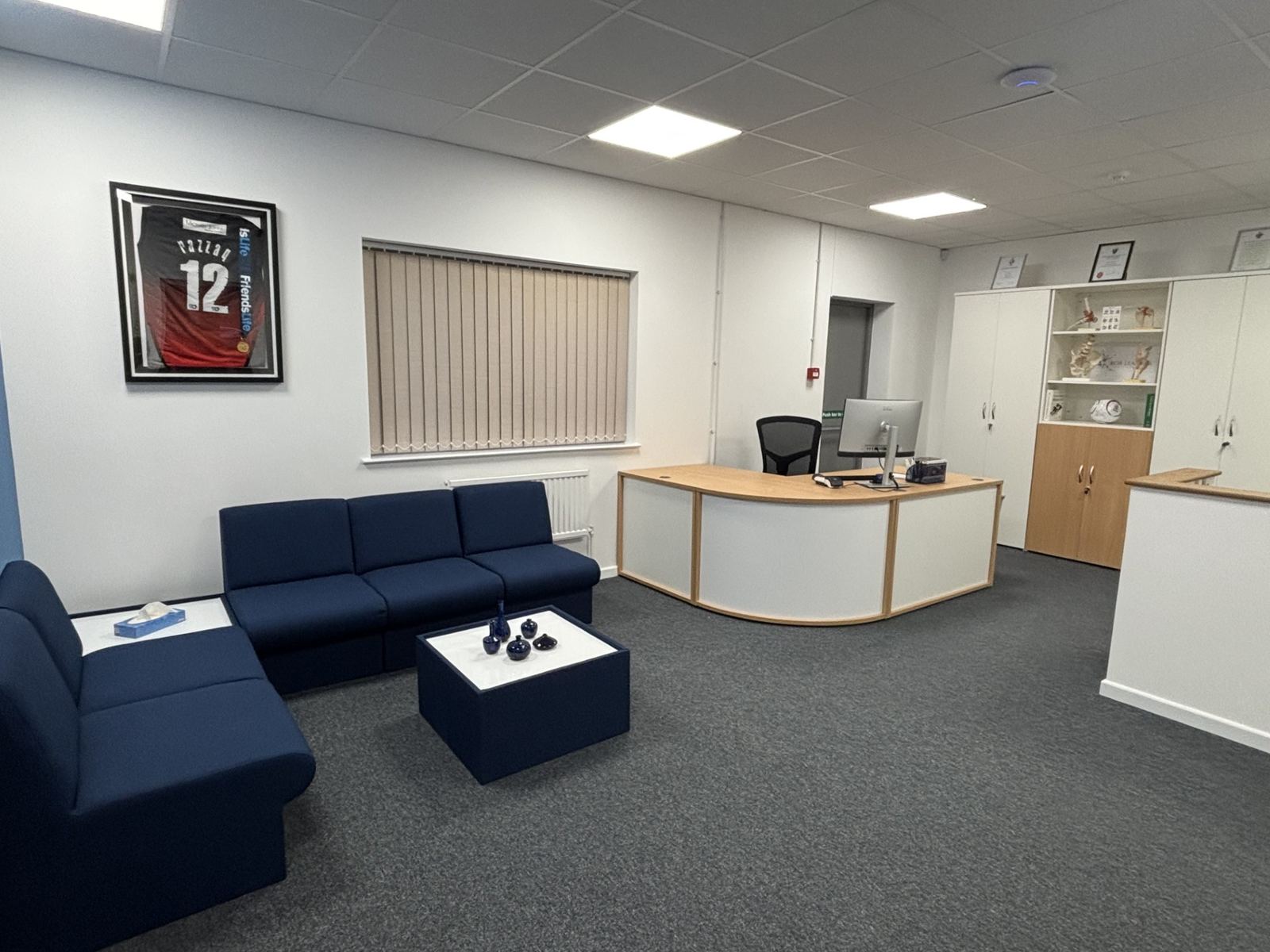 The clinic reception and waiting area with navy sofas